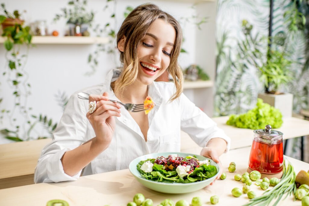 Young,Woman,Eating,Healthy,Food,Sitting,In,The,Beautiful,Interior healthy diet