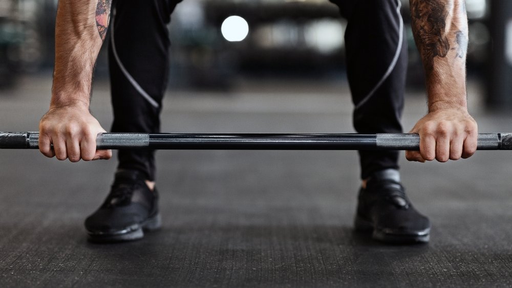 Barbell,On,Floor,And,The,Man's,Hands,On,It.,Weightlifting strength training